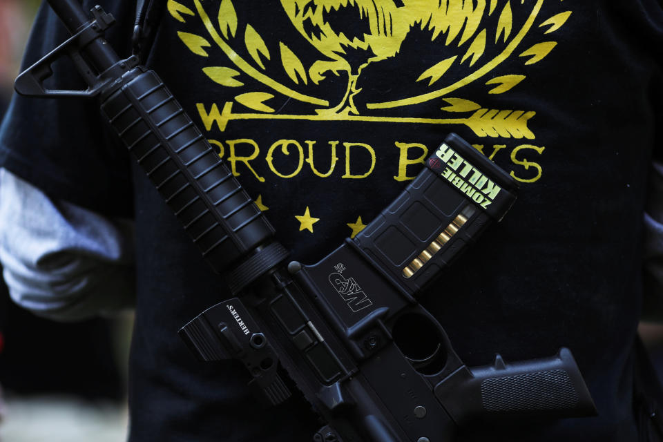 A Proud Boy carries a gun during a gathering at a local park to remember Patriot Prayer supporter Aaron J. Danielson, who was shot dead in Portland, Oregon after street clashes between supporters of President Donald Trump and counter-demonstrators, in Vancouver, Washington, U.S. September 5, 2020.  REUTERS/Caitlin Ochs