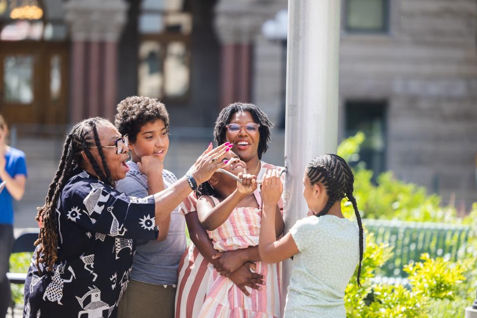 Betty Sawyer, executive director of the Project Success Coalition and Utah Juneteenth Freedom & Heritage Festival, helps siblings Xander, 12, and Zoe Clark, 9, and Ashley Cleveland and Audre Mcdonald, 6, raise the flag for Juneteenth at the Salt Lake City and County Building in Salt Lake City on June 19, 2023. | Ryan Sun, Deseret News