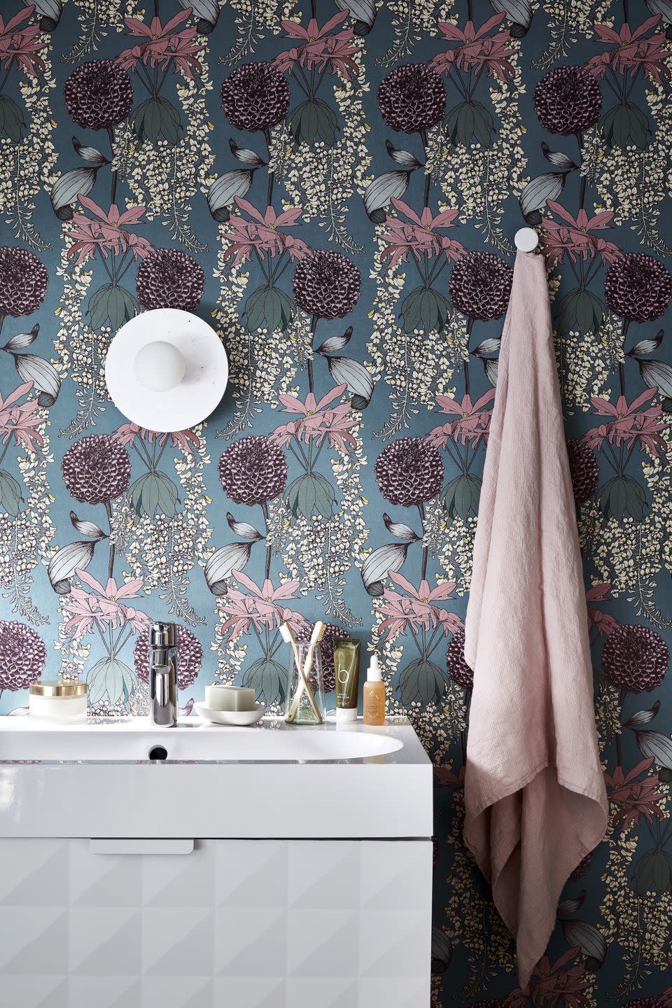 a bathroom with floral wallpaper