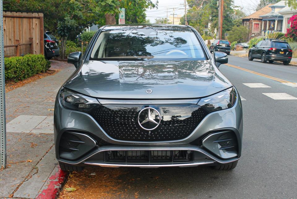 A gray Mercedes SUV parked on a street. 