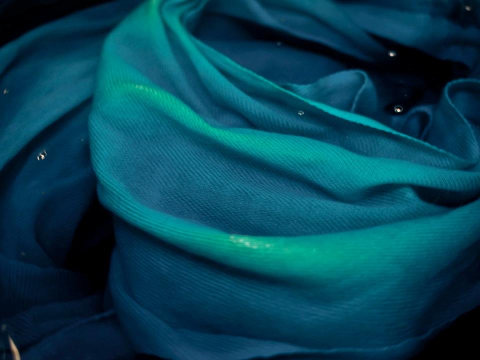A cashmere shawl is submerged into a colour dye at the workshop in Kathmandu (Paddy Dowling)