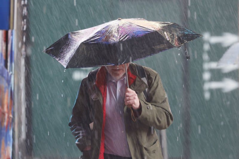 A man carries an umbrella as he walks through heavy rain in Times Square in New York City on Monday. Heavy rain and gusty winds battered New York City overnight, leaving thousands of residents without power. Photo by John Angelillo/UPI