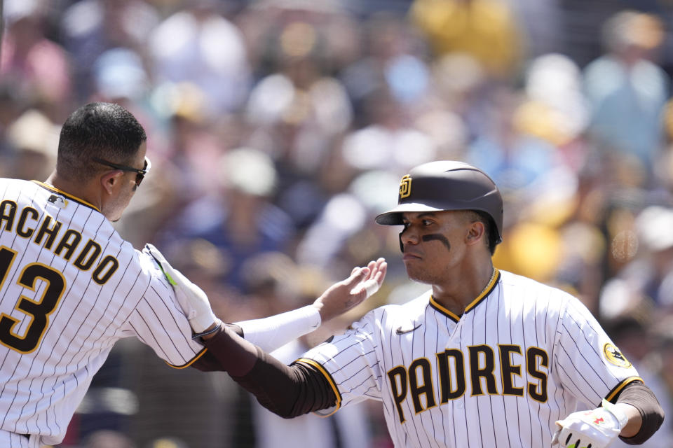 San Diego Padres' Juan Soto, right, celebrates with teammate Manny Machado after hitting a home run during the fourth inning of a baseball game against the Atlanta Braves, Wednesday, April 19, 2023, in San Diego. (AP Photo/Gregory Bull)