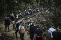 Migrants walk across the Darien Gap from Colombia to Panama in hopes of reaching the U.S., Tuesday, May 9, 2023. Pandemic-related U.S. asylum restrictions, known as Title 42, are to expire Thursday, May 11. (AP Photo/Ivan Valencia)