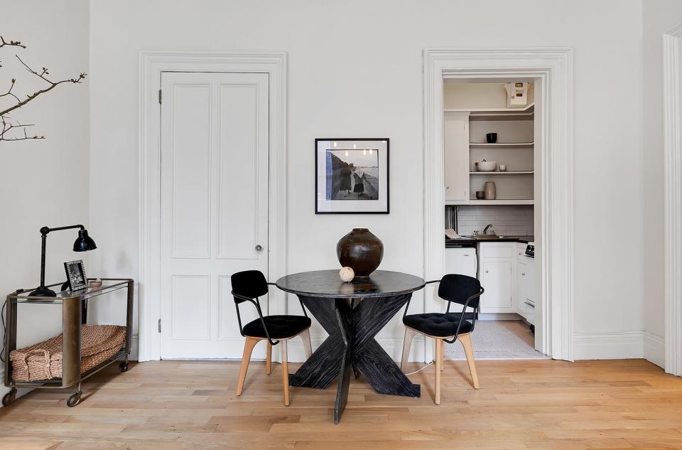 The home is decorated with a black, white, and wood color scheme.