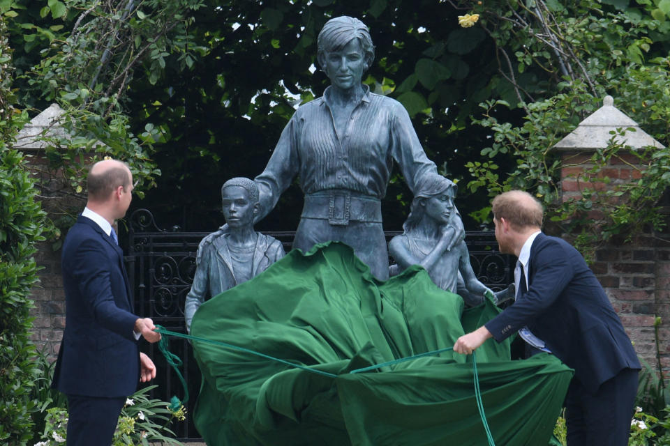 TOPSHOT - Britain's Prince William, Duke of Cambridge (L) and Britain's Prince Harry, Duke of Sussex unveil a statue of their mother, Princess Diana at The Sunken Garden in Kensington Palace, London on July 1, 2021, which would have been her 60th birthday. - Princes William and Harry set aside their differences on Thursday to unveil a new statue of their mother, Princess Diana, on what would have been her 60th birthday. (Photo by Dominic Lipinski / POOL / AFP) (Photo by DOMINIC LIPINSKI/POOL/AFP via Getty Images)