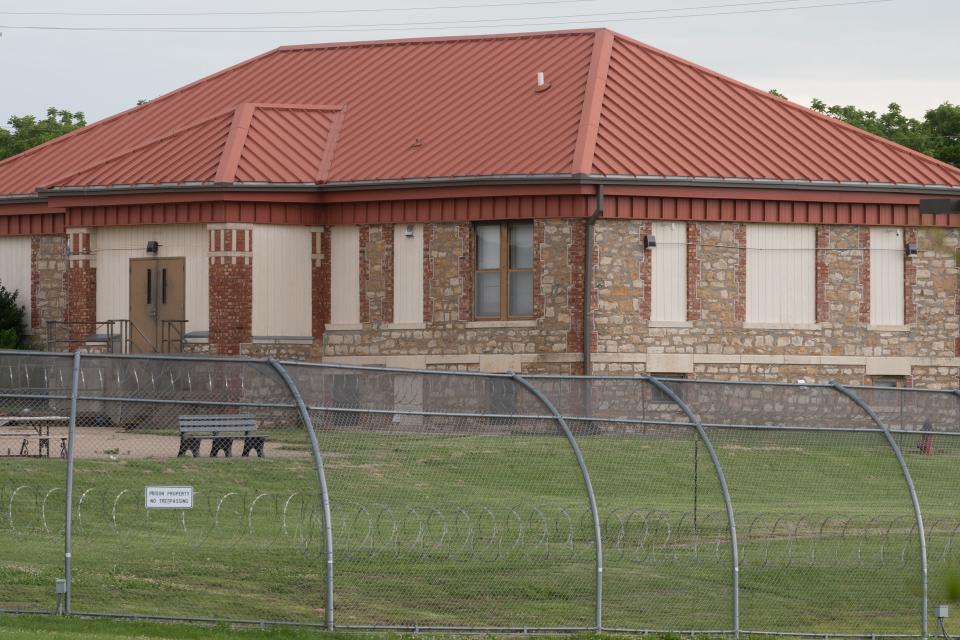 One of the original buildings from the Kansas Vocational School shows most of its windows boarded up at the Topeka Correctional Facility.