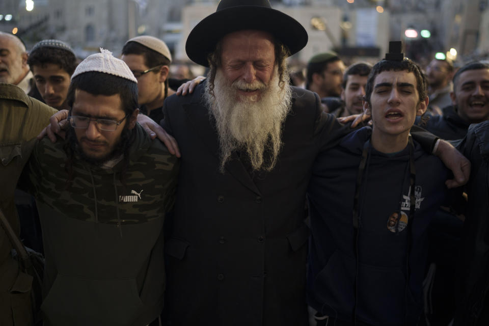 People attend a mass public prayer calling for the hostages held in the Gaza Strip to be released in front of the Western Wall, the holiest site where Jews can pray, in Jerusalem's Old City, Israel, Wednesday, Jan. 10, 2024. In its Oct. 7 attack, Hamas and other militants took captive roughly 250 people, including men, women, children and older people. Around 110 people have been released and some 110 remain, along with about 20 people who were killed while in captivity, Israeli authorities say. (AP Photo/Leo Correa)