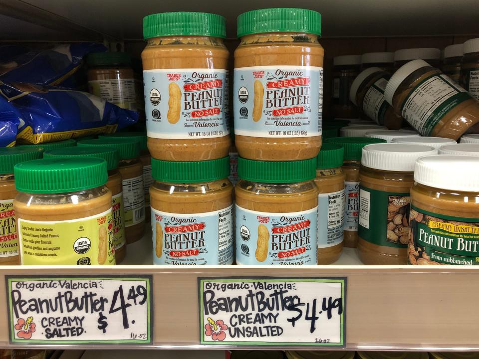 A display of Trader Joe's creamy, unsalted, Valencia peanut butter and a price tag that reads $4.49.