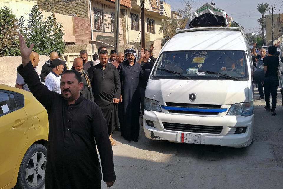 Mourners escort the flag-draped coffin of Mohammed Jassim, a protester killed in anti-government protests, during his funeral in Baghdad, Iraq, Friday, Nov. 15, 2019. Iraqi medical and security officials say one protester was killed and over 40 were wounded in renewed clashes overnight in central Baghdad. (AP Photo/Khalid Mohammed)