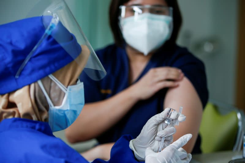 FILE PHOTO: A medical worker prepares a dose of the Sinovac's vaccine at a district health facility in Jakarta