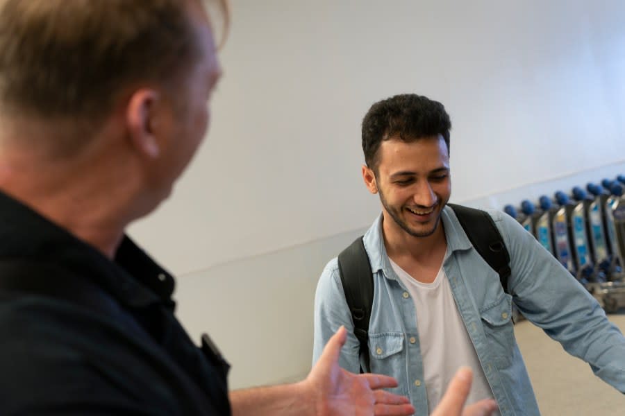 Michael White, a Navy veteran who was jailed in Iran for several years on spying charges, left, shares a light moment with Michael’s former fellow prisoner and Iranian political activist Mahdi Vatankhah at the Los Angeles International Airport in Los Angeles, Thursday, June 1, 2023. Vatankhah, while in custody and after his release, helped White by providing White’s mother with crucial, firsthand accounts about her son’s status in prison and by passing along letters White had written while he was locked up. Once freed, White did not forget. He pushed successfully this year for Vatankhah’s admission to the United States, allowing the men to be reunited last spring, something neither could have envisioned when they first met in prison years earlier. (AP Photo/Jae C. Hong)