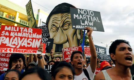 Protesters chant slogans as Philippine President Rodrigo Duterte delivers his State of the Nation address at the Congress in Quezon city, Metro Manila Philippines July 24, 2017. REUTERS/Erik De Castro