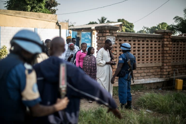 A soldier of the UN peacekeeping force MINUSCA contingent uses a metal detector at the entrance of a polling station in the flashpoint PK5 district in Bangui on December 14, 2015