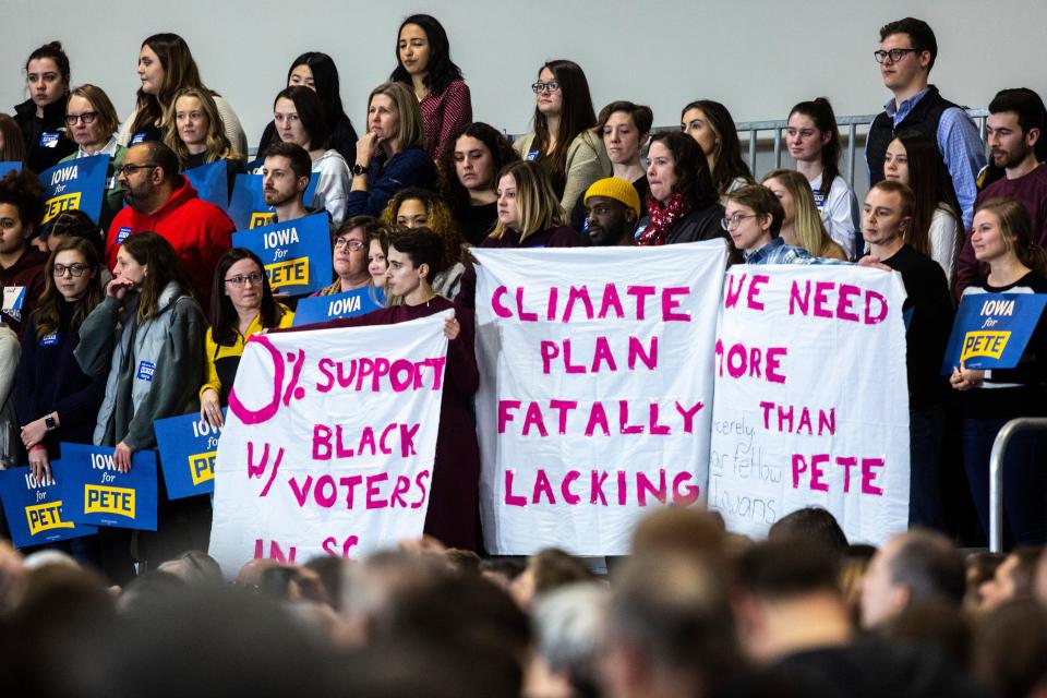 Protesters hold up sheets of fabric as Democratic presidential candidate Pete Buttigieg, mayor of South Bend, Indiana, starts to speak during a town hall, Sunday, Dec. 8, 2019, at the Coralville Marriott & Conference Center, in Coralville, Iowa.