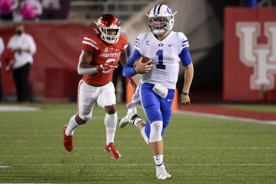 BYU quarterback Zach Wilson, right, runs past Houston safety JoVanni Stewart during the first half of an NCAA college football game, Friday, Oct. 16, 2020, in Houston. (AP Photo/Eric Christian Smith)