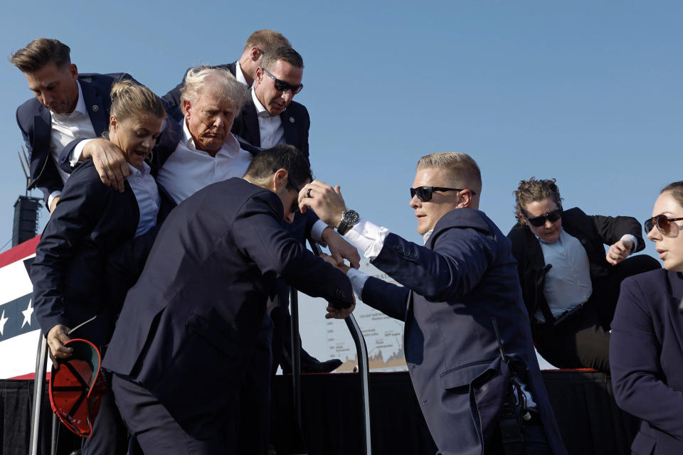 Republican presidential candidate former President Donald Trump is rushed offstage by U.S. Secret Service agents after being grazed by an apparent bullet during a rally on July 13, 2024, in Butler, Pennsylvania.