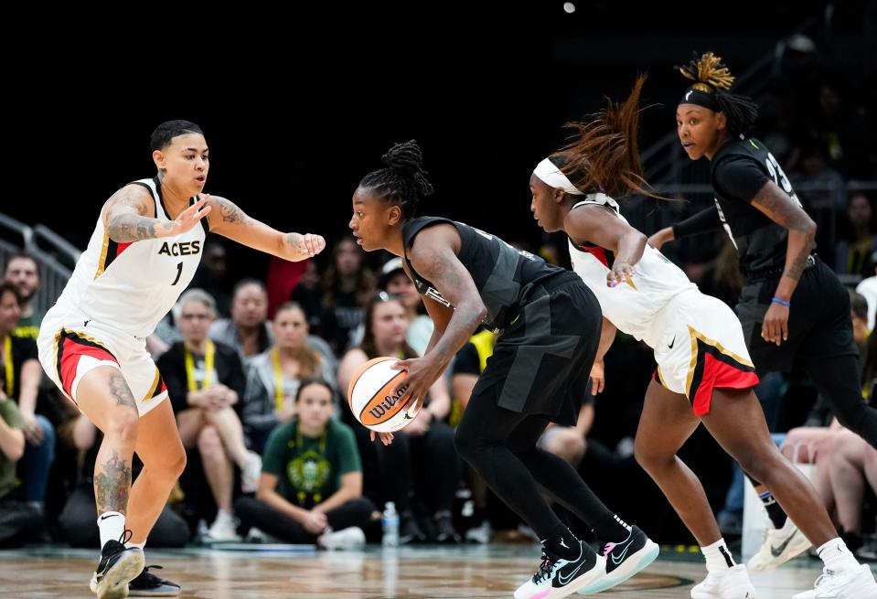 Seattle Storm guard Jewell Loyd, center, looks to drive around Las Vegas Aces guard Kierstan Bell (1) as guard Jackie Young, second from right, and guard Jordan Horston, right, look on during the second half of a WNBA game Saturday, May 20, 2023, in Seattle. The Aces won 105-64.