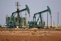 FILE - In this Wednesday, July 29, 2020 file photo, a view of a pump jack operateing in an oil field in Midland, Texas. A U.N.-backed study has found that the world needs to cut by more than half its production of coal, oil and gas in the coming decade to maintain a chance of keeping global warming from reaching dangerous levels. The report published Wednesday, Oct. 20, 2021 by the U.N. Environment Program noted that many governments have made ambitious pledges to curb greenhouse gas emissions. But it found they are still planning to extract double the amount of fossil fuels in 2030 than what would be consistent with the goal of keeping global temperature rise below 1.5 degrees Celsius (2.7 degrees Fahrenheit). (AP Photo/Tony Gutierrez, File)