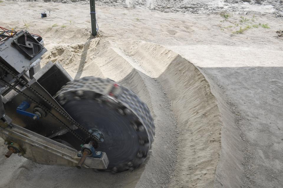 SDSU's main excavator digs into the ground as part of NASA's Break the Ice challenge in Brookings, South Dakota on Wednesday, Aug. 9, 2023. The team built the main excavator to move lunar soil semi-autonomously.