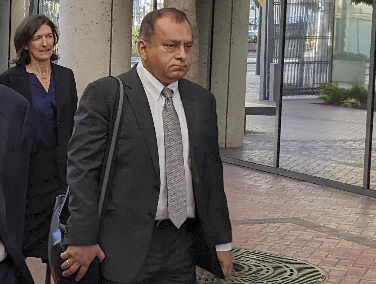 Ramesh "Sunny" Balwani, right, the former lover and business partner of Theranos CEO Elizabeth Holmes, walks into federal court in San Jose, Calif., Friday, June 24, 2022.  
