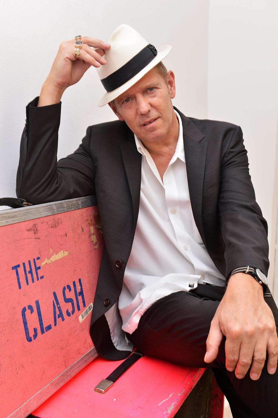 FILE - This Sept. 5, 2013 file photo shows Paul Simonon at the Black Market Clash pop-up exhibition and store in Soho to mark the release of the group's remastered collected works "Sound System" box set in London. Simonon designed the group's new box set to look like a boom box. Lift up the cover and you'll find the complete recorded output of the classic Clash lineup _ the late Joe Strummer, Mick Jones, Simonon and Topper Headon _ with outtakes, videos, fanzines, stickers, a poster and more. The survivors worked a few years to get back control of their music, remaster it and restore the original artwork. (Photo by Mark Allan /Invision/AP)