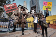 <p>Konstantine Anthony, left, joins other grassroots protestors during a rally against gun violence in downtown Los Angeles on Monday, Feb. 19, 2018. Hundreds of sign-carrying, chanting protesters have converged on a downtown Los Angeles park, demanding tougher background checks and other gun-safety measures following last week’s deadly school shooting in Florida. (Photo: Richard Vogel/AP) </p>