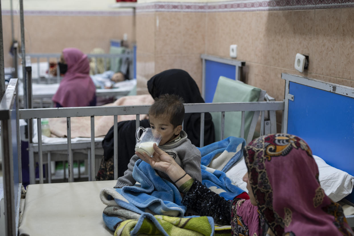 20 year-old Parwana gives milk to her two year-old son Mohammad as he undergoes treatment in the malnutrition ward of the Indira Gandhi Children's Hospital in Kabul, Afghanistan, on Wednesday, Dec. 8, 2021. Afghanistan's health care system, is on the brink of collapse and able to function only with a lifeline from aid organisations. (AP Photo/Petros Giannakouris)