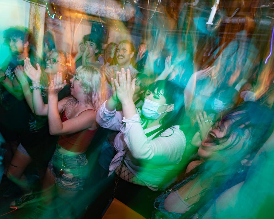 Guests at Davey Grumbine's house venue applaud during the concert portion of Vulva Vengeance, a art showcase and fundraiser for the Missouri Abortion Fund on July 23, 2022.