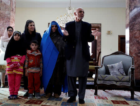 Afghanistan's President Ashraf Ghani (R) speaks to media and after Sharbat Gula (2nd R) the green-eyed Afghan woman arrived in Kabul, Afghanistan November 9, 2016. REUTERS/Mohammad Ismail