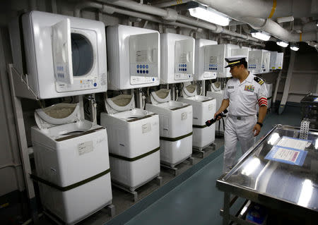 A crew member conducts a safety patrol in a laundry room at Japanese helicopter carrier Kaga anchored near Jakarta Port ahead of its departure for naval drills in the Indian Ocean, Indonesia September 21, 2018. Picture taken on September 21, 2018. REUTERS/Kim Kyung-Hoon