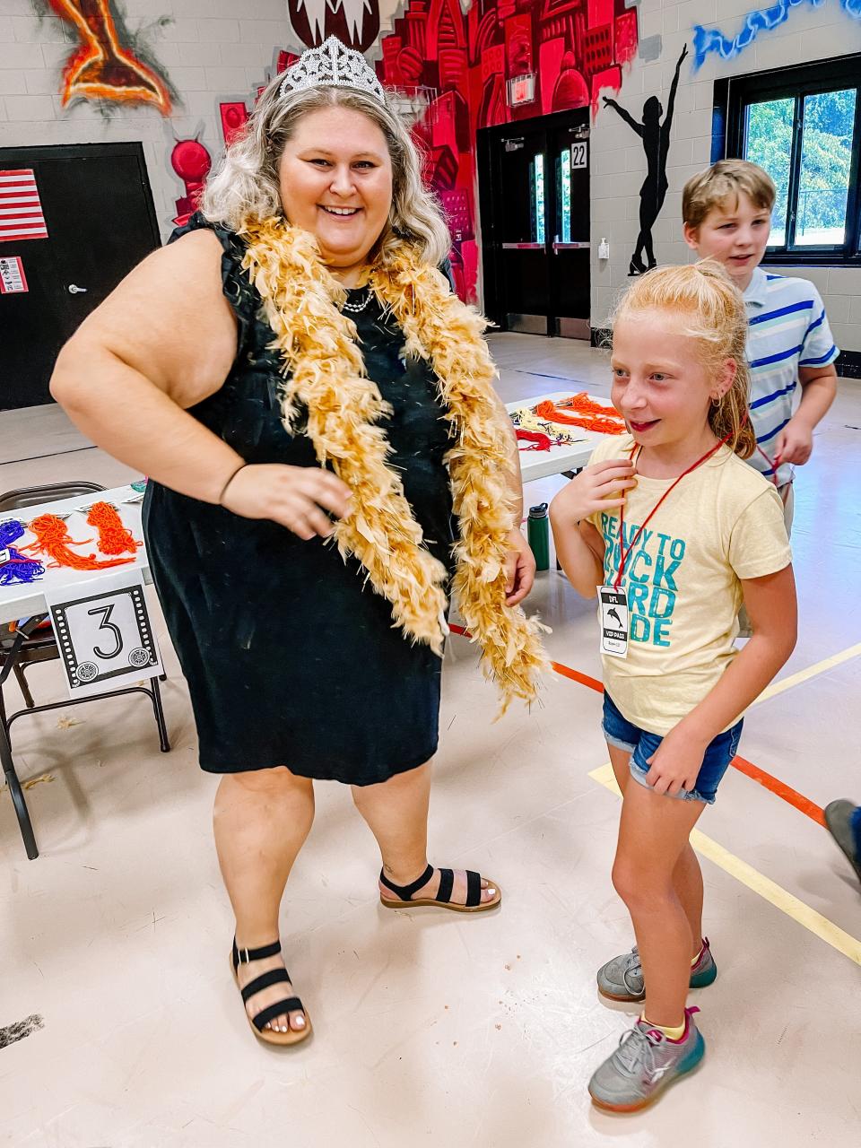 Special Education teacher Lucy Fall presents third grader Amiyah Miller with her “VIP Backstage Pass” with her room number for this school year at Dogwood Elementary School’s Back to School Premiere event on Aug. 3, 2022.