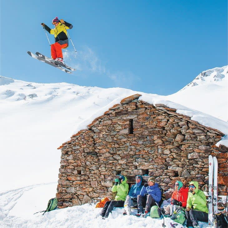 Earle skiing in the French Alps in 2016. He's going over a building as a jump.