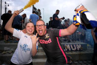 Leeds United fans celebrate outside Elland Road after Huddersfield Town beat West Bromwich Albion to seal their promotion to the Premier League.