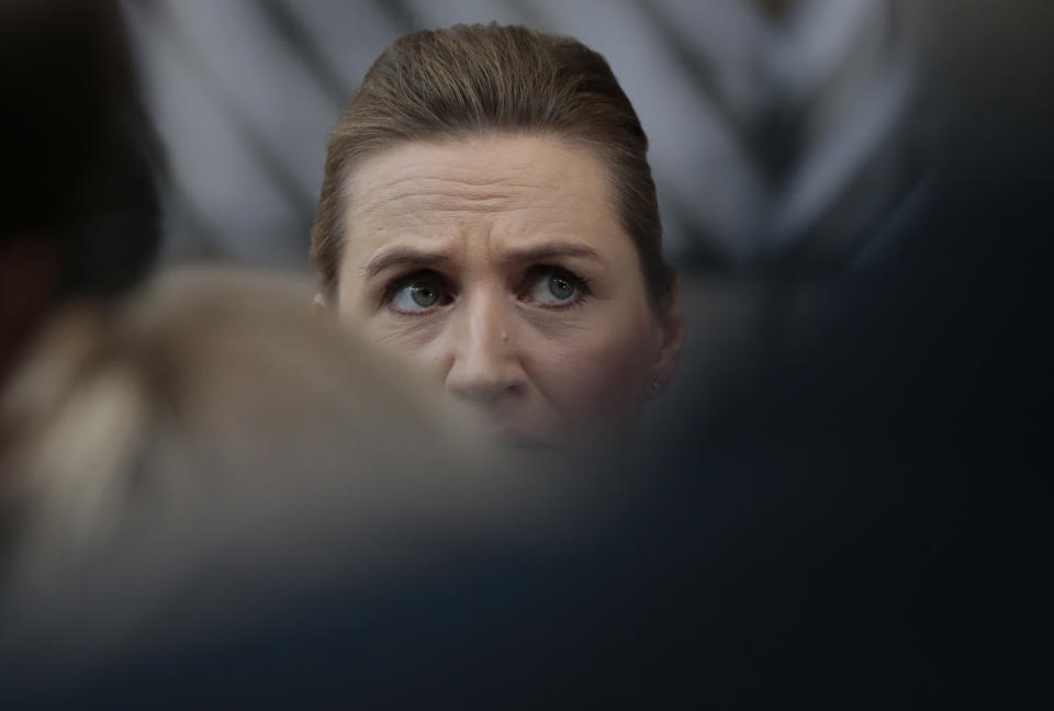 Danish Prime Minister Mette Frederiksen speaks with the media as she arrives for an EU summit at the European Council building in Brussels, Friday, Feb. 21, 2020. In a second day of meetings EU leaders will continue to discuss the bloc's budget to work out Europe's spending plans for the next seven years. (AP Photo/Virginia Mayo)