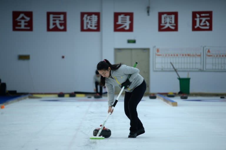 Curling sees athletes slide heavy, circular granite stones across a stretch of ice towards a target, with two sweepers wielding brooms rushing along the stone's path in an attempt to influence its track without touching the rock