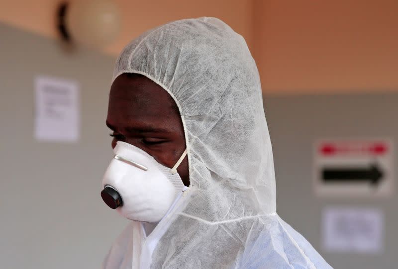 FILE PHOTO: A health worker wears a protective suit during a training exercise to deal with any potential coronavirus cases at a hospital in Harare