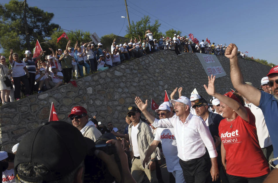 FILE - People greet Kemal Kilicdaroglu, center, the leader of Turkey's main opposition Republican People's Party, CHP, as he arrives with thousands of supporters on the 18th day of his 425-kilometer (265-mile) "March for justice" in Kocaeli, Turkey, on Sunday, July 2, 2017. Kilicdaroglu, the main challenger to President Recep Tayyip Erdogan in the May 14 election, cuts a starkly different figure than the incumbent who has led the country for two decades. As the polarizing Erdogan has grown increasingly authoritarian, Kilicdaroglu has a reputation as a bridge builder and vows to restore democracy. (AP Photo, File)