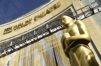 FILE - In this Feb. 24, 2016, file photo, an Oscar statue is pictured underneath the entrance to the Dolby Theatre in Los Angeles. When the Oscars broadcast begins April 25 on ABC, there won’t be an audience. The base of the show won’t be the Academy Awards’ usual home, the Dolby Theatre (though the Dolby will still be involved), but Union Station, the airy, Art Deco-Mission Revival railway hub in downtown Los Angeles. For the producers, the challenges of COVID are an opportunity to, finally, rethink the Oscars. (Photo by Chris Pizzello/Invision/AP, File)