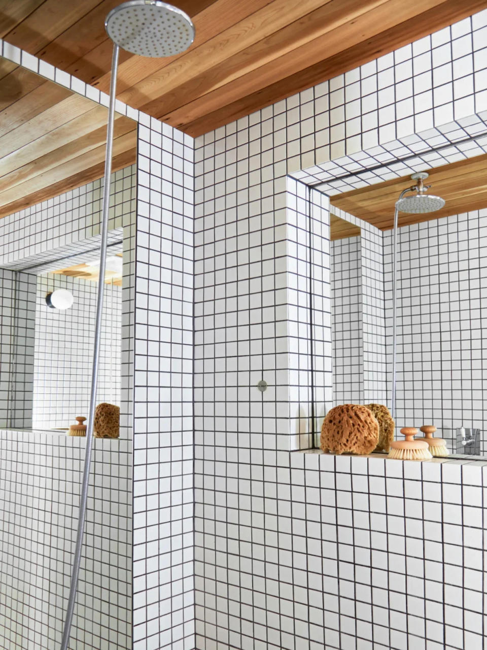 White tiled bathroom shower with cedar lining. 