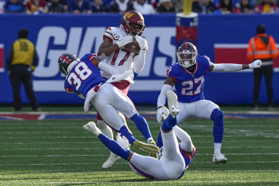 Washington Commanders' Terry McLaurin, top, makes a catch during the first half of an NFL football game against the New York Giants, Sunday, Dec. 4, 2022, in East Rutherford, N.J. (AP Photo/John Minchillo)