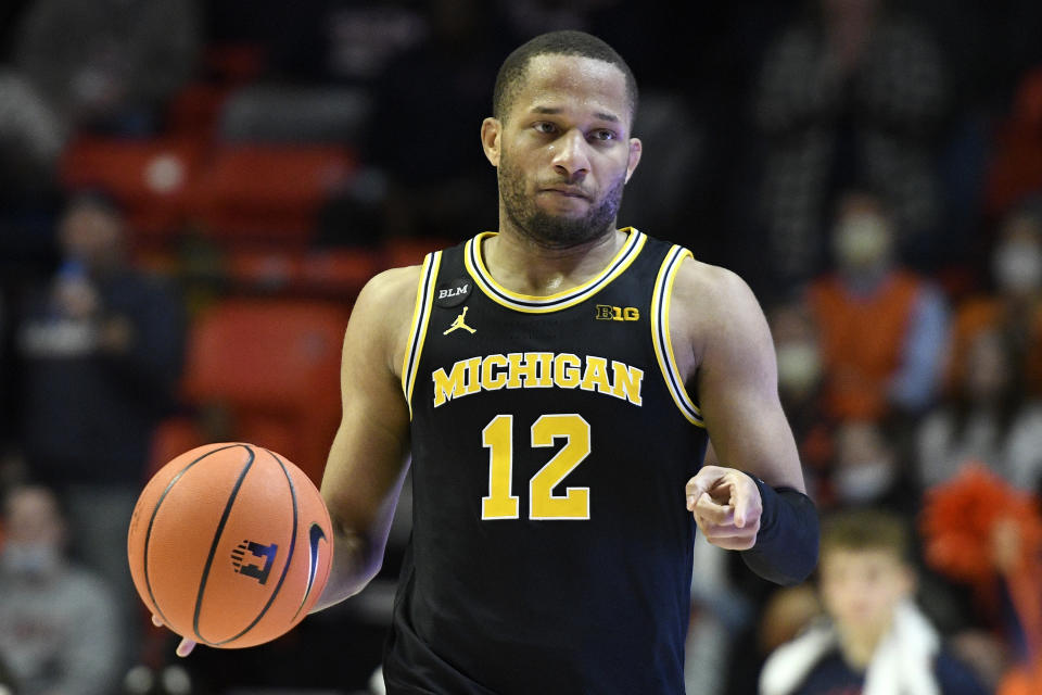 Michigan's DeVante' Jones signals during the second half of an NCAA college basketball game against Illinois Friday, Jan. 14, 2022, in Champaign, Ill. (AP Photo/Michael Allio)