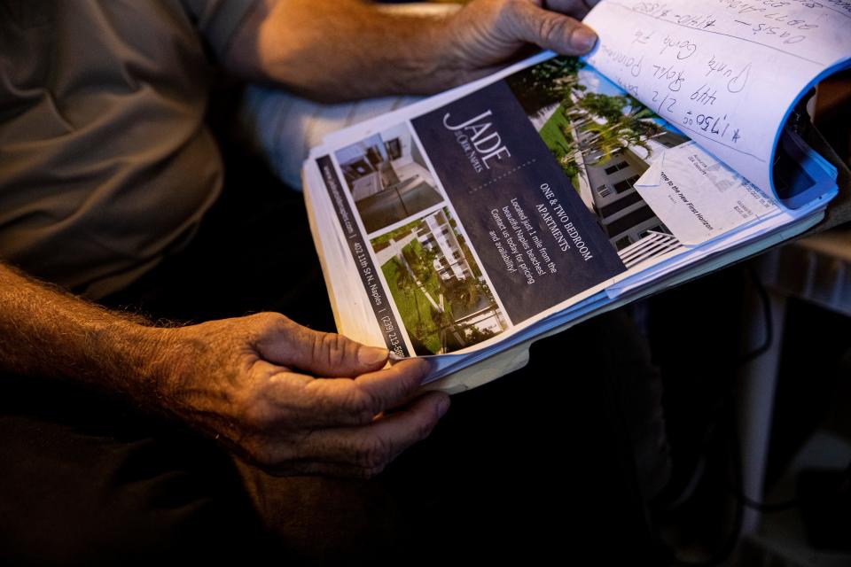 Todd Murray displays rental property documents at his Naples duplex he shares with his brother Tommas on Tuesday, June 7, 2022. They say the duplex has been sold and that they have to be out by July 31. Tommas is on disability and Todd has a full time job at a local market. They say they can't afford another place to live because the rents are too high and the ones they can afford don't take pets. Tommas has a cat. They are afraid that they may become homeless.