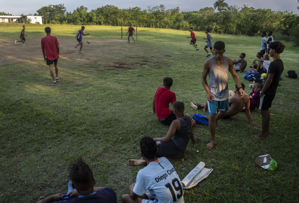 Locals play soccer on an old baseball field in the Santa Fe municipality of Guanabacoa east of Havana, Cuba, Saturday, Oct. 15, 2022. The island's situation has prompted well-known Cuban soccer players to defect during regional tournaments, with several joining teams in the U.S. in the past two decades as talent drains from an island that FIFA currently ranks 167 out of 211 countries. (AP Photo/Ramon Espinosa)