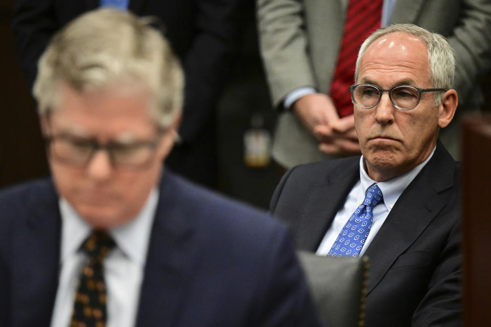 Former FirstEnergy Senior Vice President Michael Dowling sits in the courtroom behind his lawyer John McCaffrey inside the courtroom at the Summit County courthouse in Akron, Ohio on Tuesday, Feb. 13, 2024. Two fired executives of FirstEnergy Corp. and a former top state utilities regulator pleaded not guilty Tuesday to state charges related to a $60 million bribery scheme that centered on securing a legislative bailout for two Ohio nuclear power plants with the help of a powerful House speaker. (AP Photo/David Dermer)