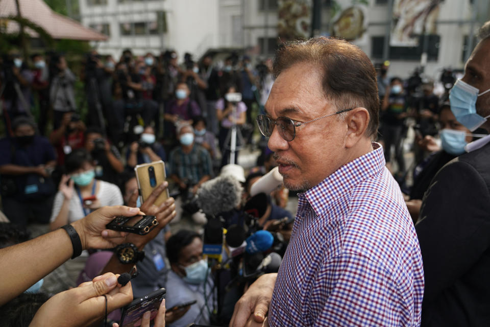 Malaysian opposition leader Anwar Ibrahim speaks to media after leaving the police headquarters in Kuala Lumpur, Malaysia, Friday, Oct. 16, 2020. Anwar was questioned by police over the dissemination of a purported list of lawmakers supporting his bid to oust the government. (AP Photo/Vincent Thian)