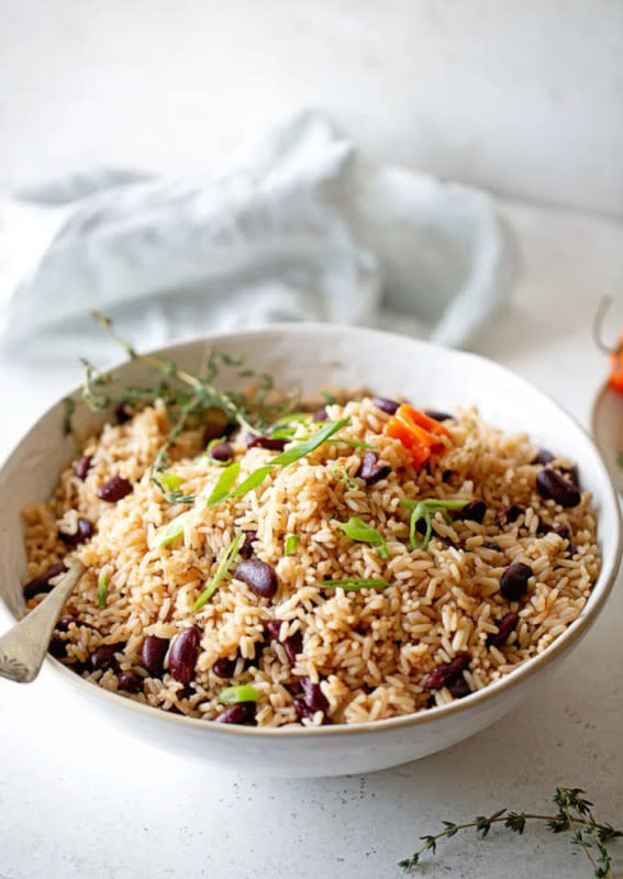 <p>Grandbaby Cakes</p><p>This Jamaican Rice and Peas Recipe is the BEST quintessential and authentic Caribbean side with perfectly fluffed rice and delicious red beans with a hint of coconut flavor and spices galore.</p><p><strong>Get the recipe: <a href="https://grandbaby-cakes.com/rice-and-peas/" rel="nofollow noopener" target="_blank" data-ylk="slk:Jamaican Rice and Peas Recipe;elm:context_link;itc:0;sec:content-canvas" class="link rapid-noclick-resp">Jamaican Rice and Peas Recipe</a></strong></p>