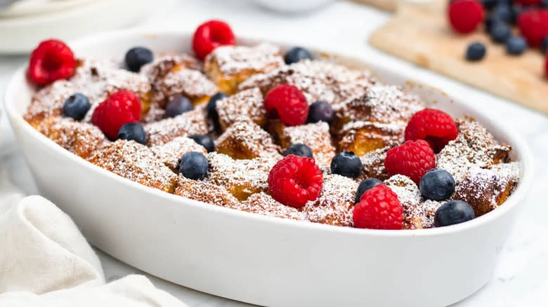 French toast in a dish with blueberries and raspberries