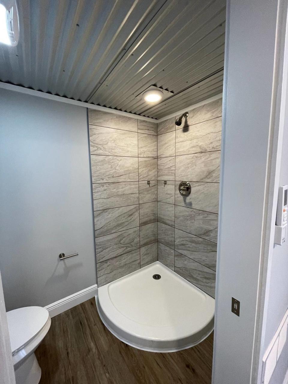 The bathroom with shower in a 20-foot shipping container.