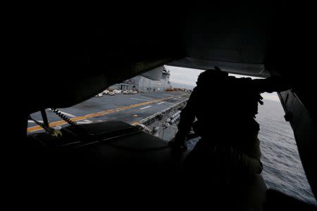 A crewman aboard a U.S. Marines MV-22B Osprey Aircraft looks out over the deck of the USS Bonhomme Richard amphibious assault ship before landing on it off the coast of Sydney, Australia, at the start of Talisman Saber 2017, a biennial joint military exercise between the United States and Australia June 29, 2017. REUTERS/Jason Reed